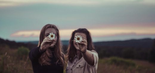 two women holding flowers